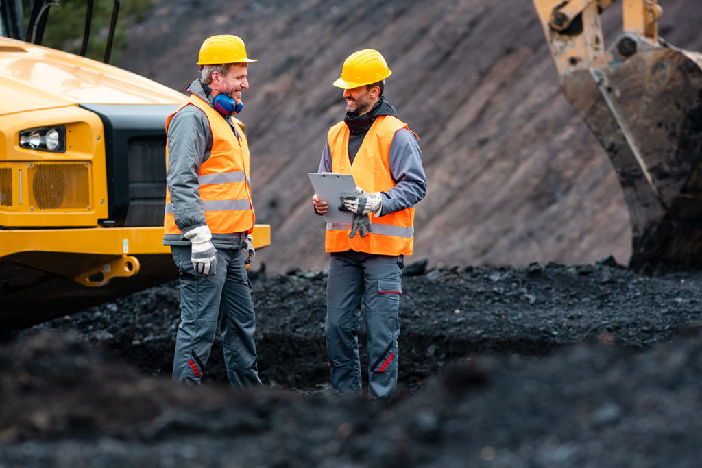 Miners conversing on a worksite
